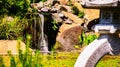 A small waterfall in a Japanese garden. Royalty Free Stock Photo