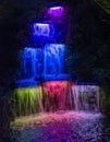 Small waterfall  lit up with lights during the festival of lights in Pukekura Park, New Plymouth Royalty Free Stock Photo