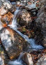 Small waterfall in a mountain gorge Royalty Free Stock Photo