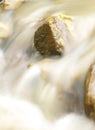 Small waterfall in the mountain river. Beautiful natural background of stones and with flowing, blurring water and foaming. Royalty Free Stock Photo