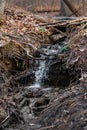 A small waterfall in a natural creek area , running rapid with spring snow melt Royalty Free Stock Photo