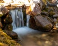 Small waterfall in nature with moss covered rocks Royalty Free Stock Photo