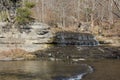 Small waterfall over rocks at the juncture of two streams, winter