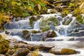 Small Waterfall in park with beautifull smooth water. Little waterfall in mountain forest with silky foaming water. Royalty Free Stock Photo