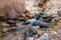 Small waterfall in path of the shallow stream in the gorge Wadi Al Ghuwayr or An Nakhil and the wadi Al Dathneh near Amman in