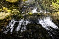 A small waterfall photographed from above in the direction of flow