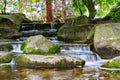 Small waterfall in public zen garden Royalty Free Stock Photo