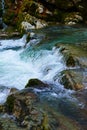 small waterfall on a river with blue clean water in a wild forest Royalty Free Stock Photo