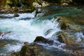 small waterfall on a river with blue clean water in a wild forest Royalty Free Stock Photo