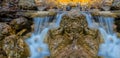 Small waterfall on a river rushing ower the stones