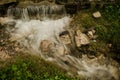 Small waterfall with running water, silk effect, natural waterfall landscape