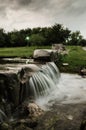 Small waterfall with running water, silk effect, natural waterfall landscape Royalty Free Stock Photo