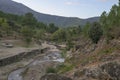 Small waterfall among smooth granite rocks in mountain stream Jevero Acebo panoramic Royalty Free Stock Photo