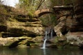 Small waterfall with a stone bridge in Hocking Hills State Park, Ohio Royalty Free Stock Photo