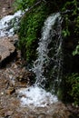 A waterfall, stones and grass