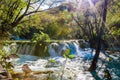 Small waterfall with sunlight rays Royalty Free Stock Photo