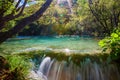 Small waterfall with sunlight rays Royalty Free Stock Photo