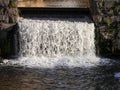 A small waterfall under a bridge Royalty Free Stock Photo