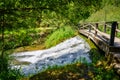 Small waterfall under a wooden bridge at the source of the Ebro river. Fontibre Cantabria Royalty Free Stock Photo