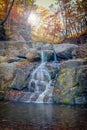 Small waterfalls cascade in autumn season colors in the forest in Russia Royalty Free Stock Photo