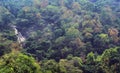 A small waterfalls with hill trees