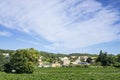 Small wave of beautiful white fluffy clouds on vivid blue sky in a summer time above houses on the mountain, vineyard Royalty Free Stock Photo