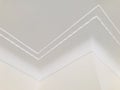 Small wave pattern crown molding in luxury home ceiling. Ornamental at the zigzag corner. Royalty Free Stock Photo