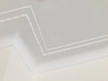 Small wave pattern crown molding in luxury home ceiling. Ornamental at the zigzag curve corner. Royalty Free Stock Photo