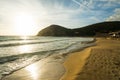 Small waves by La Speranza beach shore at sunset