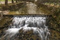 Small weir on Belca creek near bridge in Bohinjska Bistrica in Slovenia Royalty Free Stock Photo