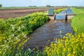 Small weir for water level control in a Dutch polder Royalty Free Stock Photo