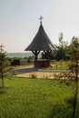 Small well with a cross on a sunny morning