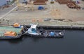 A small well kept Tug alongside the quay with its Barge awaiting loading of equipment at Den Haag Container Terminal.