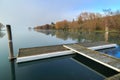 A small wharf on a lake on a misty autumn morning Royalty Free Stock Photo