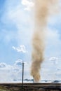 Small whirl formed on burnt out field on sunny day Royalty Free Stock Photo