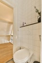 a small white bathroom with a toilet and a staircase Royalty Free Stock Photo