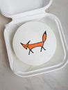 Small white bento cake with a drawn fox as a gift for the holiday. mock up for design Royalty Free Stock Photo