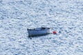 Small white boat attached to a red buoy in Olshoremore, Scotland Royalty Free Stock Photo