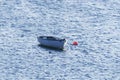 Small white boat attached to a red buoy in Olshoremore, Scotland Royalty Free Stock Photo