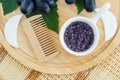 Small white bowl with homemade grape and sugar body scrub bath salt, foot soak and wooden hairbrush. Natural beauty treatment an Royalty Free Stock Photo