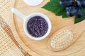 Small white bowl with homemade grape and sugar body scrub foot soak and wooden hairbrush. Natural beauty treatment and spa Royalty Free Stock Photo