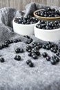 Small White Bowl of Organic Blueberries on Wooden Table with kitchen towel. Copy space. Summer fruit berries Royalty Free Stock Photo