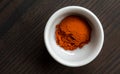Small white bowl with red pepper powder Royalty Free Stock Photo