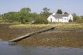 A small white bungalow on the water`s edge