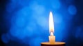A small, white candle with a bright steady flame Royalty Free Stock Photo