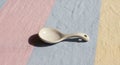 A small, white ceramic spoon rests Royalty Free Stock Photo