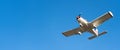 Small white cessna single propeller plane flying in a clear blue sky maneuvering before landing at Sabadell airport Royalty Free Stock Photo