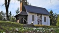 Small white chapel on a hill behind white flowers with bokehe effect Royalty Free Stock Photo