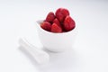 Small white china bowl filled with succulent juicy fresh ripe red strawberries Royalty Free Stock Photo