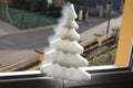 small white glittering Christmas tree at the window Royalty Free Stock Photo